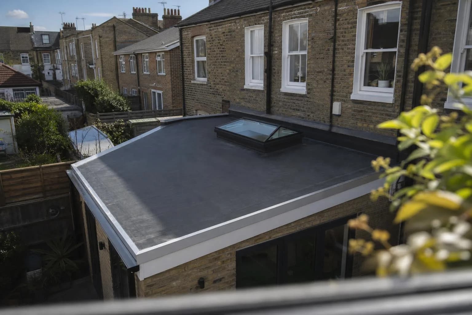 A newly covered flat roof on the rear extension of a terraced house